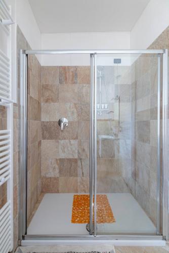a shower with a glass door in a bathroom at B&B Castello Cimbergo in Cimbergo
