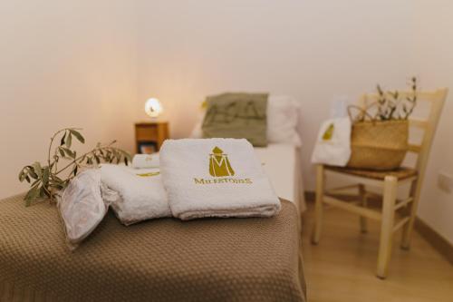 a room with a bed with a towel on top of it at Milestones Modern Suite Trullo Jacuzzi Spa & Relax in Alberobello