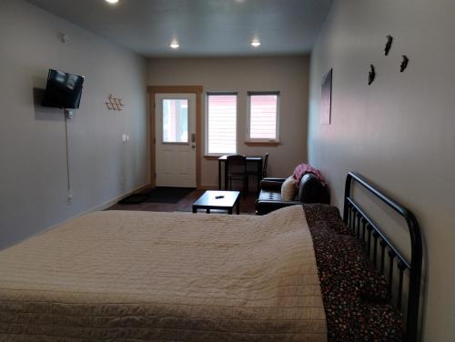 a bedroom with a bed and a living room at Grewingk Suite - Homer Seaplane Base in Homer