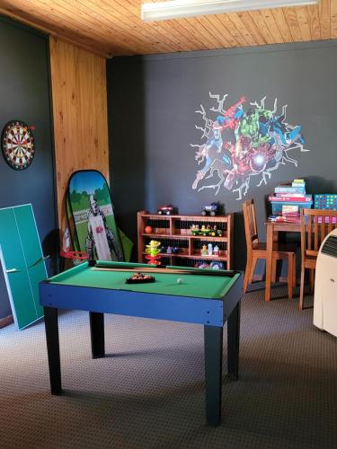 a room with a pool table and a dining room at Blue Wren BnB Bathurst in Bathurst