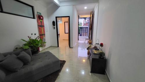 a living room with a couch and a hallway at Amazonia Deluxe Calle 13 in Leticia