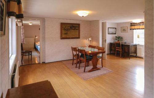 a dining room and living room with a table and chairs at Amazing Home In Hovmantorp With Wifi in Hovmantorp