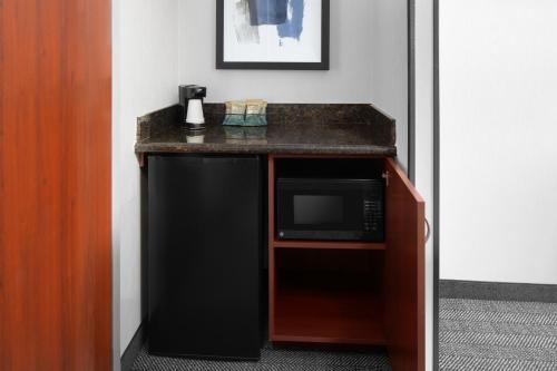 a kitchen with a black microwave and a counter at Courtyard by Marriott San Diego Rancho Bernardo in Rancho Bernardo