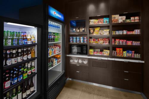 a store aisle with a refrigerator and lots of drinks at Courtyard by Marriott San Diego Rancho Bernardo in Rancho Bernardo