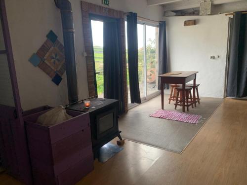 a living room with a tv and a table at House with Forest View in Lajes das Flores