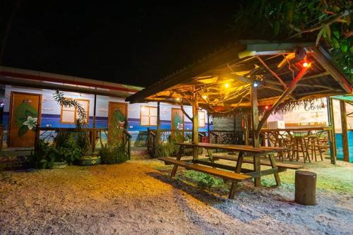 a picnic table in front of a restaurant at night at Moorea Vaiare Lodge in Moorea