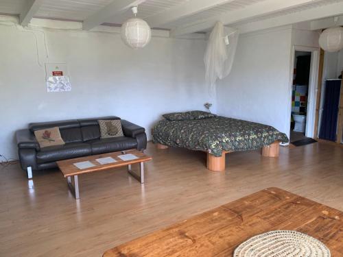 a living room with a couch and a table at House with Forest View in Lajes das Flores