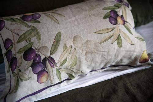 a pillow with a floral pattern on a bed at Villa in Agello in Agello
