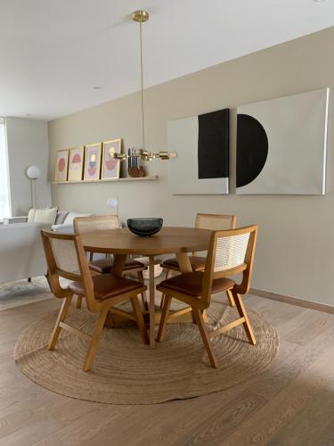 a dining room with a wooden table and chairs at New Apartment in the heart of Polanco in Mexico City