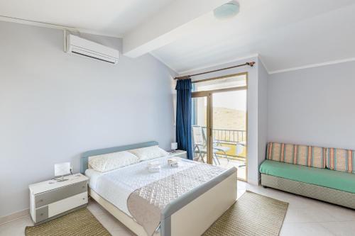a bedroom with a bed and a balcony at Studio Brsec 7796a in Martina