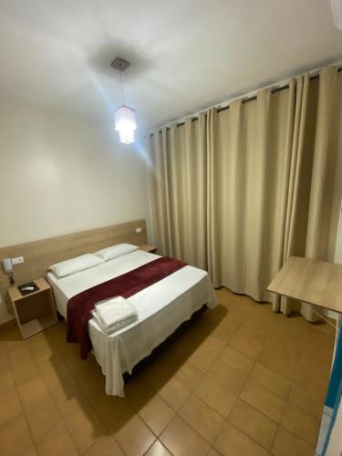 Una cama o camas en una habitación de Hotel Novo México