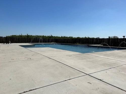 a swimming pool in a yard with a fence at Adorable One Bedroom Cottage in Oakdale