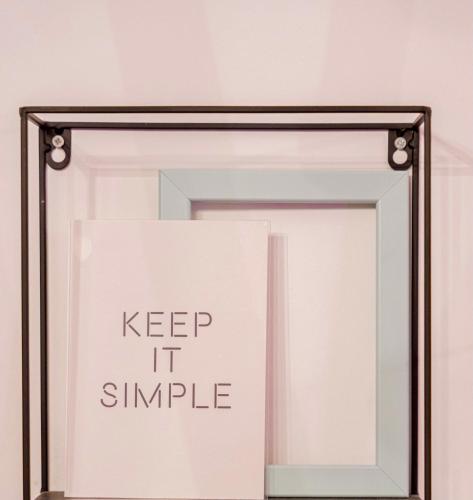 a framed mirror with the words keep it simple at Lilly's House in Volos