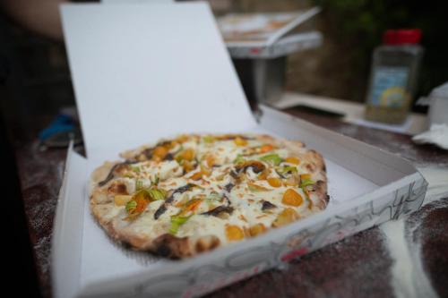 a pizza sitting in a box on a table at Villa in Agello in Agello