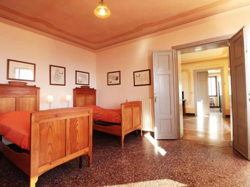 a bedroom with two beds and an open door at Apartment in Valbelluna with Pool & Dolomites View in Santa Giustina