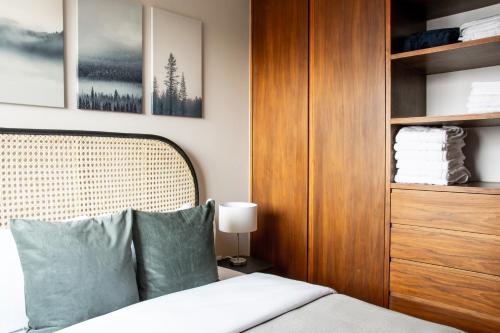 a bedroom with a bed and a wooden cabinet at New Modern Apartment in Polanco in Mexico City