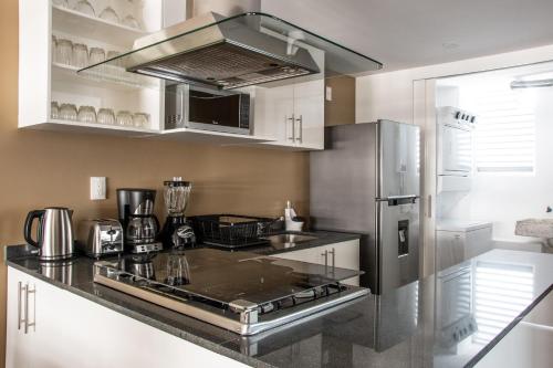 a kitchen with a stainless steel refrigerator and counter top at New Modern Apartment in Polanco in Mexico City