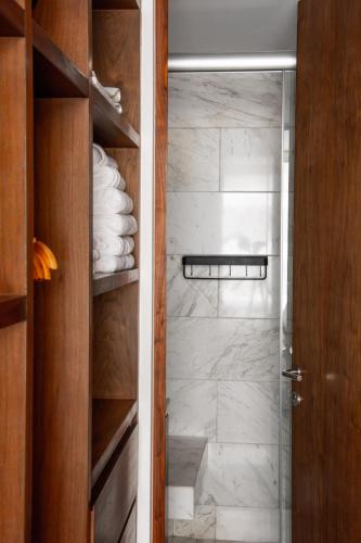 a bathroom with a walk in shower with a glass door at New Modern Apartment in Polanco in Mexico City