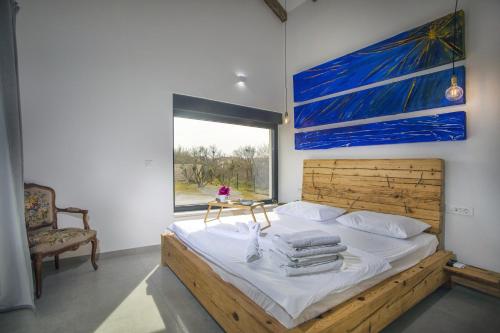 Schlafzimmer mit einem Bett mit Wandgemälde in der Unterkunft Luxury villa with a swimming pool Privlaka, Zadar - 18623 in Privlaka