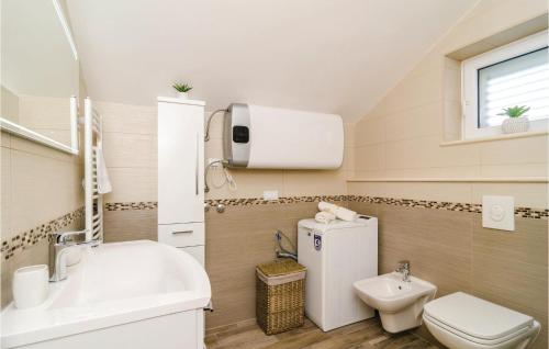 a small bathroom with a sink and a toilet at Lovely Apartment In Cibaca With Kitchen in Mlini
