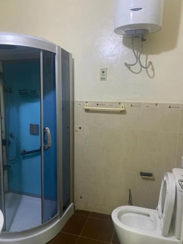 a bathroom with a shower and a toilet in it at CHEZ CODOU Fann Hock in Dakar