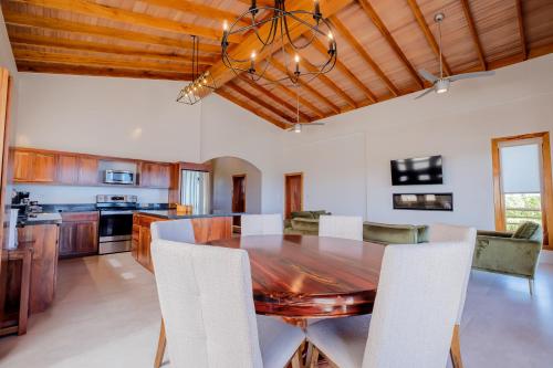 a dining room with a wooden table and chairs at Suite 2 at Island Pearl Gold Standard Certified in Caye Caulker