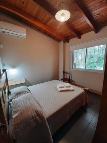 a bedroom with a bed with two towels on it at Departamento Los Girasoles in Guaymallen