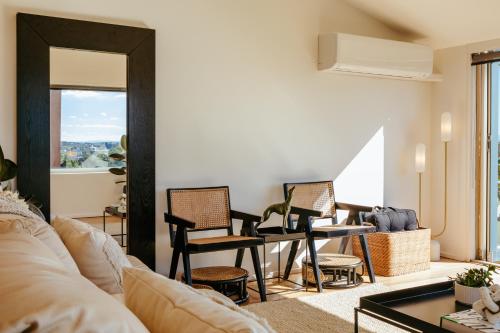 a living room with a table and chairs at Spectacular views over Albert Park in Melbourne