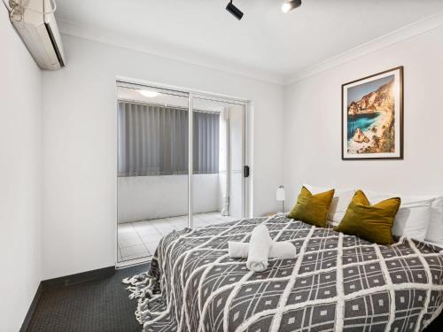 a bedroom with a large bed with green pillows at Spacious 2 Bed 2 Bath Apartment at South Brisbane in Brisbane