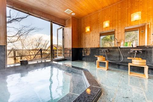 a large bathroom with a tub and a shower at Noёl HAKONE GENSEN in Hakone
