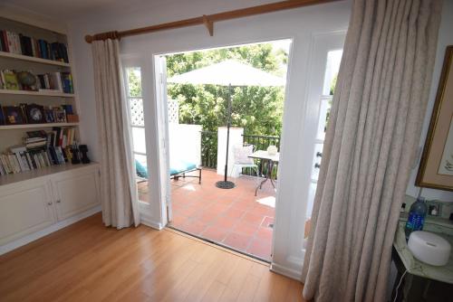 a living room with a door open to a patio at Beverly Hills Celebrity Home in Los Angeles