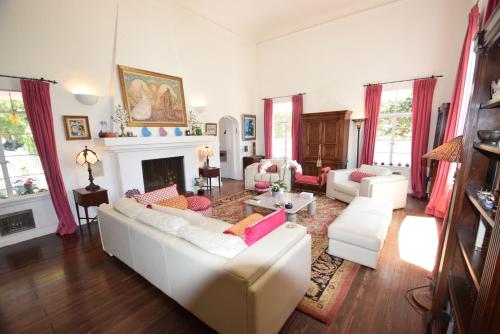 a living room with a white couch and a fireplace at Beverly Hills Celebrity Home in Los Angeles