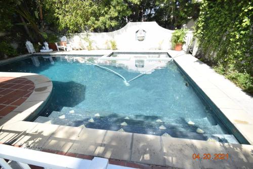 a swimming pool in a backyard with at Beverly Hills Celebrity Home in Los Angeles