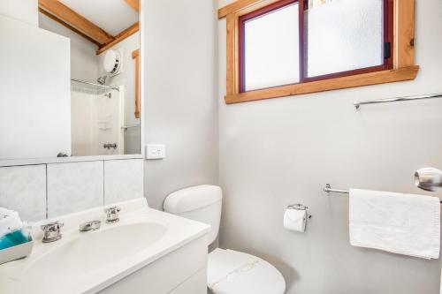 a bathroom with a sink and a toilet and a window at Breeze Holiday Parks - Grampians in Halls Gap