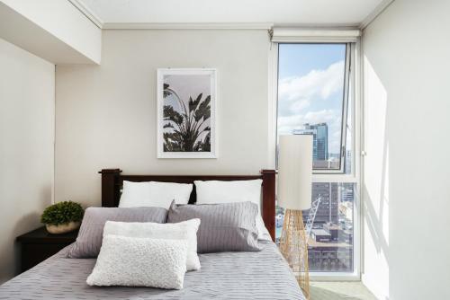 a bedroom with a bed and a large window at Phenomenal City View Central Location 2BD Apart in Brisbane