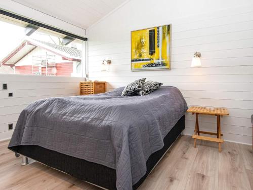 a bedroom with a bed in a room with white walls at Holiday home Aabenraa LXXI in Aabenraa