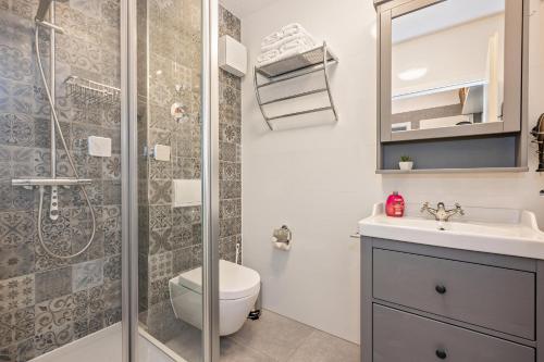 a bathroom with a shower and a toilet and a sink at Haus Miramar 09 in Ahlbeck