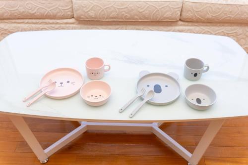 a white coffee table with cups and saucers on it at Noёl HAKONE GENSEN in Hakone