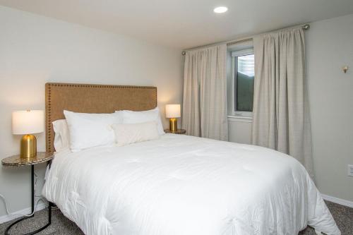 a bedroom with a large white bed and a window at NEW Charming Home in the Heart of North Fargo in Fargo
