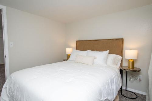 a bedroom with a large white bed with two lamps at NEW Charming Home in the Heart of North Fargo in Fargo