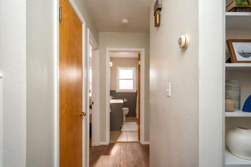 a hallway with a bathroom with a toilet in a room at NEW Charming Home in the Heart of North Fargo in Fargo
