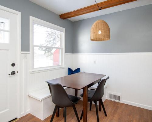 a dining room with a wooden table and chairs at NEW Charming Home in the Heart of North Fargo in Fargo