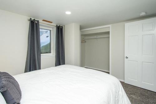 a bedroom with a white bed and a window at NEW Charming Home in the Heart of North Fargo in Fargo