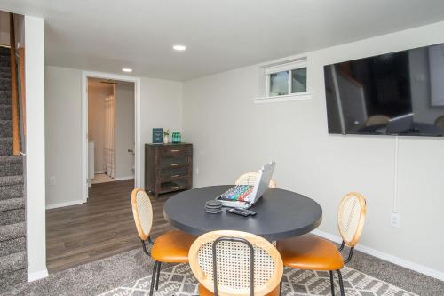 a room with a table and chairs with a laptop on it at NEW Charming Home in the Heart of North Fargo in Fargo