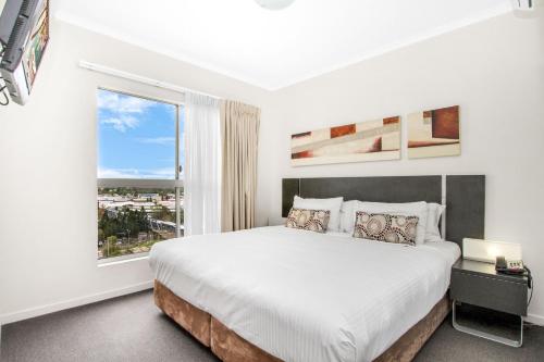 a white bedroom with a large bed and a window at OLD - Welcoming & Comfortable 1BR Retreat in Ipswich