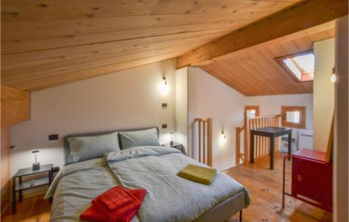 a bedroom with a large bed with wooden ceilings at Lovely Home In Pieve Di Soligo With Wifi in Pieve di Soligo