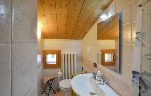 a bathroom with a sink and a toilet and a mirror at Lovely Home In Pieve Di Soligo With Wifi in Pieve di Soligo