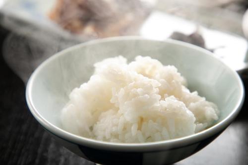 a white bowl filled with rice on a table at Tsukasa Ryokan in Saga