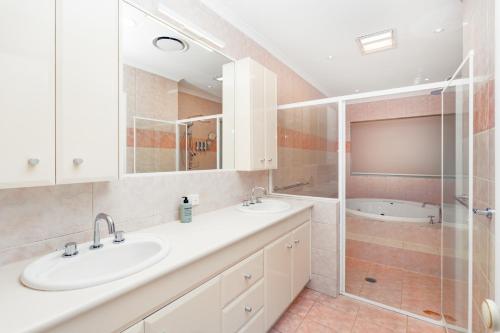 a bathroom with two sinks and a shower at Panarama Waterview! Waterfront Luxury Holiday Heave in GC in Gold Coast