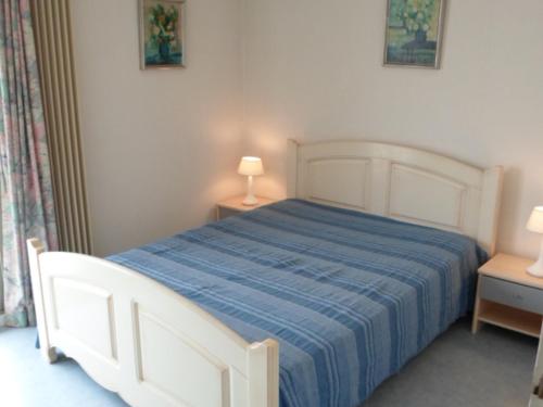 a bedroom with a white bed with a blue blanket at Appartement Les Sables-d'Olonne, 3 pièces, 6 personnes - FR-1-197-185 in Les Sables-d'Olonne